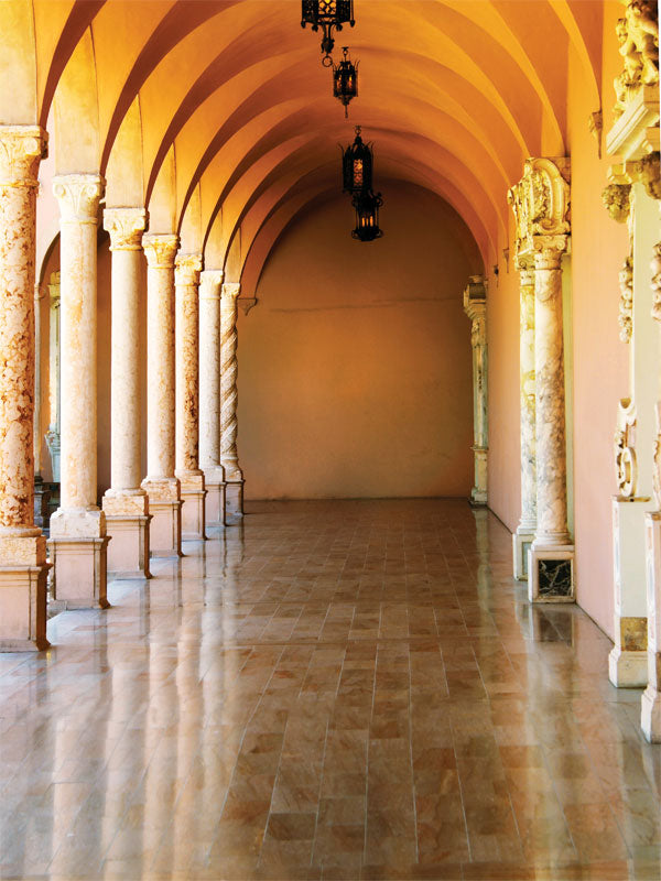 An elegant photography backdrop featuring golden archways, marble columns, and reflective floor tiles in a classical corridor.