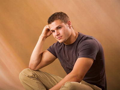 Warm, flowing abstract backdrop with golden brown and neutral color movement.