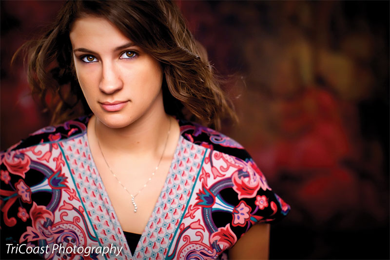 Backdrop with deep grains and vibrant reds over dark shadows.