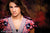 Backdrop with deep grains and vibrant reds over dark shadows.