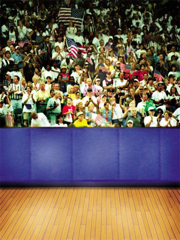 Gymnasium photography backdrop with a polished wooden floor, blue sideline padding, and an excited cheering crowd.