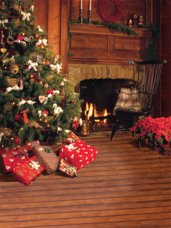 A cozy Christmas backdrop featuring a decorated tree, lit fireplace, wrapped gifts, and warm wooden floors.