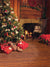 A cozy Christmas backdrop featuring a decorated tree, lit fireplace, wrapped gifts, and warm wooden floors.