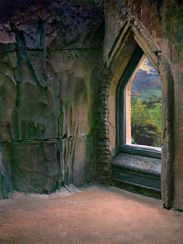 A medieval-inspired photography backdrop featuring a weathered stone interior with an arched window overlooking a scenic countryside.