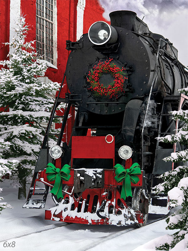 Holiday Express Train Photography Backdrop - Photography backdrop featuring a vintage steam train decorated with a festive wreath and green ribbons, set in a snowy winter scene with pine trees.