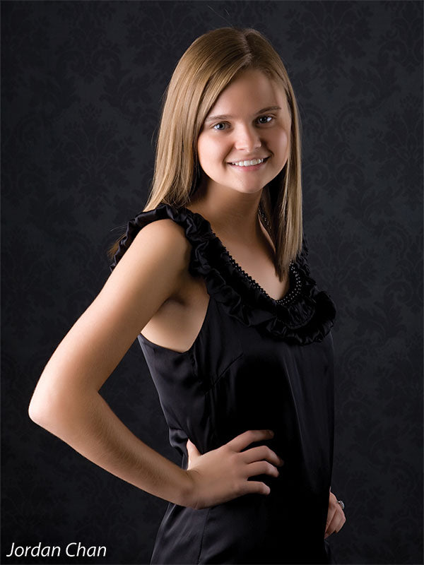 Sophisticated black backdrop with pattern, ideal for formal studio portraits