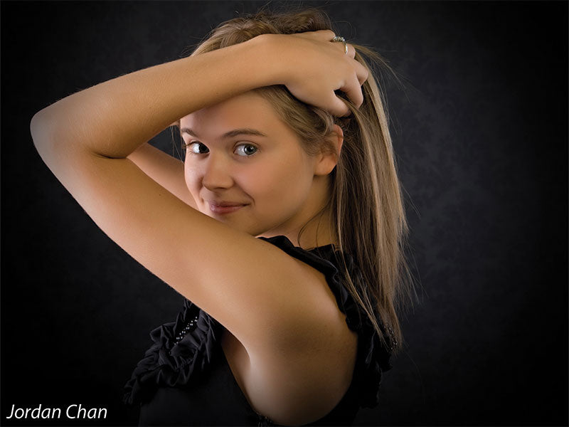 High-end damask backdrop with low-key lighting perfect for editorial portraits