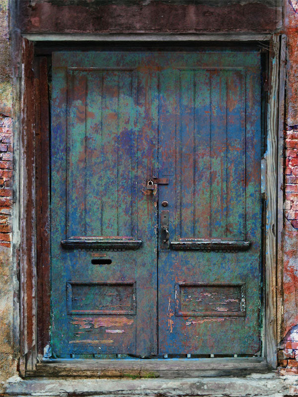 Distressed blue-green door photo backdrop with rustic brick.