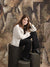 An artistic backdrop featuring layered shapes in warm neutral colors, perfect for stylized portrait sessions.