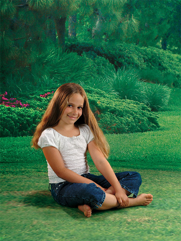 A beautifully manicured landscape backdrop with layered greenery, ideal for portrait and lifestyle photography.