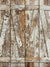 Rustic barn door with weathered wood and chipped paint, ideal as a vintage-inspired backdrop for professional photography.