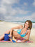 Peaceful shoreline with fluffy clouds, sea grass, and gentle surf for summer shoots.