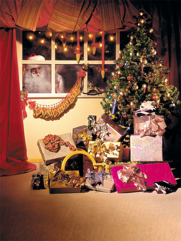 A festive Christmas photography backdrop featuring a decorated tree, glowing presents, and Santa Claus peeking through a frosty window.