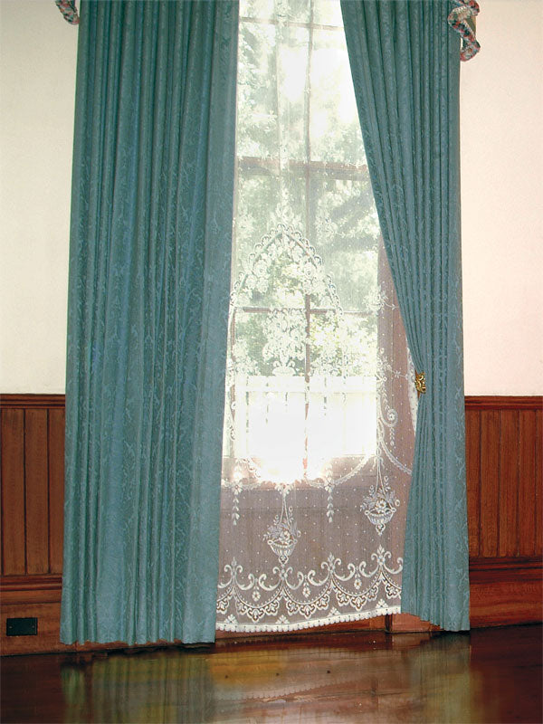A vintage photography backdrop featuring flowing teal drapes, a lace curtain, and rich wood paneling, evoking a Southern plantation charm.