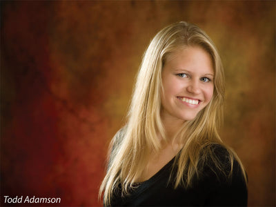 A dramatic studio backdrop with vintage warmth and rustic depth.