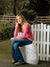 Peaceful outdoor scene with blooming flowers and rustic fence.
