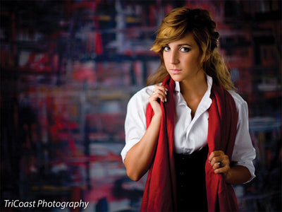 A city-inspired painted backdrop with expressive red and black brush patterns.