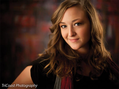 Backdrop featuring bold red brush lines contrasted by cool dark and neutral tones.