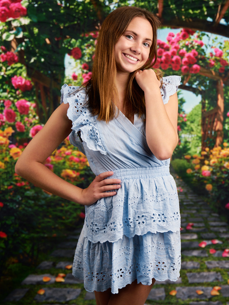 Photography backdrop featuring a romantic rose-covered arbor with cascading blooms and a cobblestone path, ideal for wedding and portrait photography.