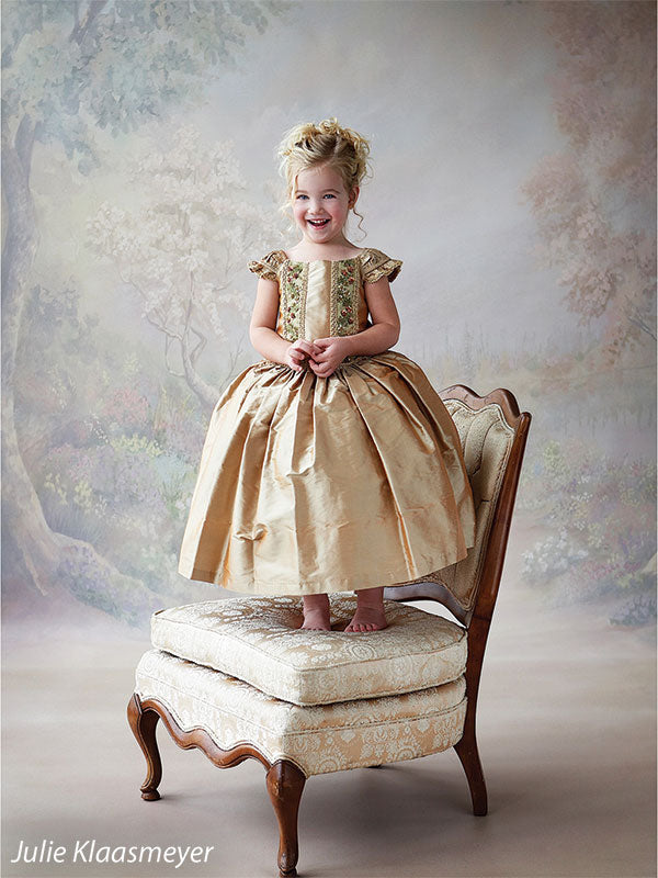 Delicate pinks, purples, and greens create a romantic floral portrait setting.