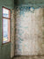 Rustic Abandoned Room Photography Backdrop - Photography backdrop featuring a rustic, abandoned room with peeling paint and natural light streaming through a window, perfect for vintage-themed and artistic photoshoots.