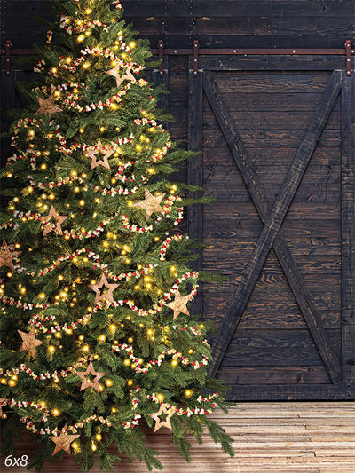 Rustic Barn Door Christmas Tree Photography Backdrop - Rustic barn door Christmas backdrop with a glowing tree, burlap stars, and popcorn garland, ideal for holiday photography.