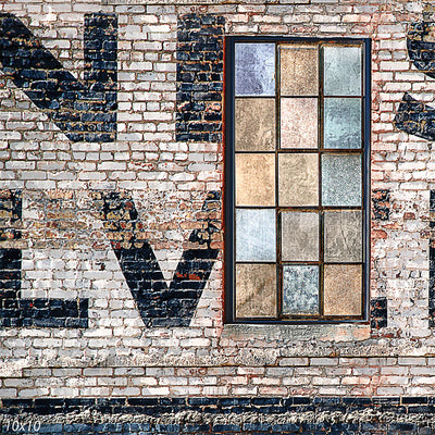 Rustic brick wall backdrop featuring a distressed industrial-style multi-pane window with weathered textures, creating an urban loft aesthetic.