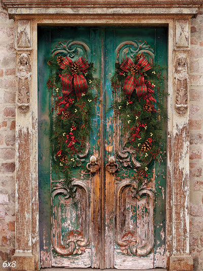 Rustic Christmas Door Photography Backdrop - A rustic wooden door with festive garlands, pine cones, and plaid bows, perfect for holiday-themed photography.