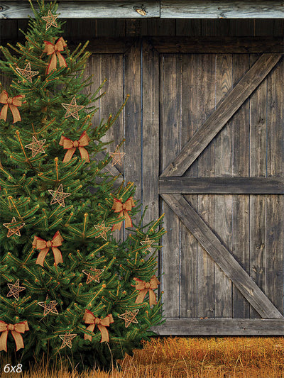 Rustic Christmas Tree and Barn Photography Backdrop - Rustic Christmas tree with bows and stars against a weathered barn backdrop, ideal for holiday and winter-themed photography.