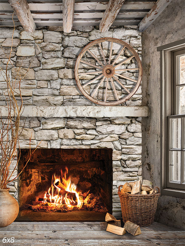 Rustic Stone Fireplace Photography Backdrop - Rustic stone fireplace photography backdrop with a roaring fire and wooden wagon wheel, perfect for cozy and homely photoshoots.