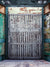 Rustic Urban Industrial Gate Photography Backdrop - Rustic urban industrial gate photography backdrop with worn metal and weathered brick wall.