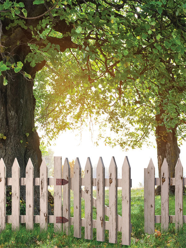 Rustic White Picket Fence Photography Backdrop - Photography backdrop featuring a rustic white picket fence under trees with sunlight, ideal for family or children's outdoor-themed photoshoots.