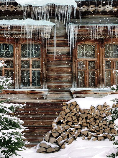 Rustic Winter Cabin Photography Backdrop - A rustic winter cabin photography backdrop featuring a snow-covered wooden cabin, frosted windows, icicles, and stacked firewood.