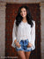 Ornate door knocker detail adds richness to portrait setup.