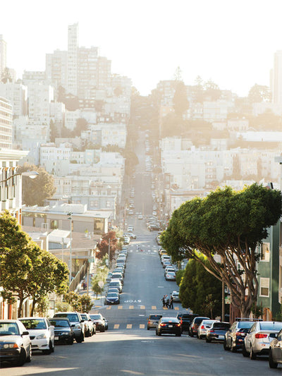 San Francisco Steep Street Photography Backdrop - San Francisco steep street photography backdrop with pastel houses, trees, and a warm golden sunlight glow. Perfect for urban-themed photoshoots.