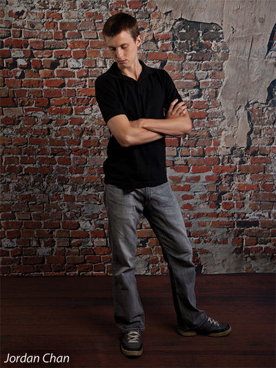 Rustic red brick photography backdrop with weathered stucco accents.