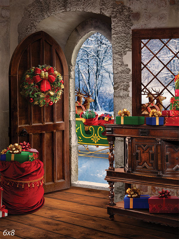 Santa's Christmas Workshop Photography Backdrop - A Christmas photography backdrop featuring Santa's workshop with a festive door opening to reveal Santa's sleigh and a snowy forest background.