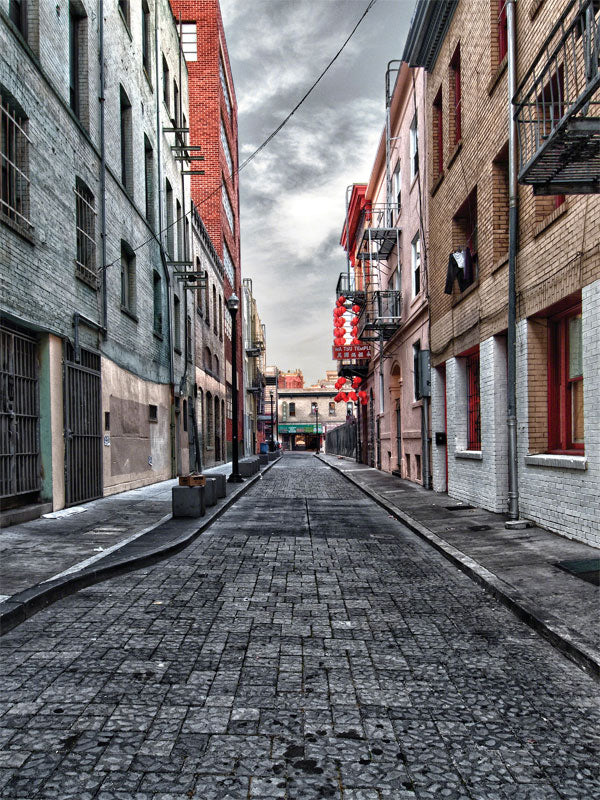 Secluded Urban Alley Photography Backdrop - Secluded alleyway with tall buildings, cobblestone street, and red lanterns, perfect for urban and city vibe photoshoots.