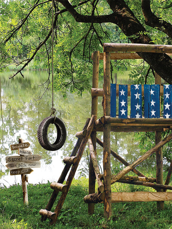 Secret Forest Fort Photography Backdrop - Photography backdrop of a secret forest fort with a tire swing, rustic wooden structure, and playful signs by a lake.