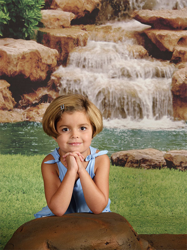 A calming nature backdrop showcasing a scenic waterfall flowing into a pond, framed by dense greenery—great for spa, meditation, and wedding photoshoots.