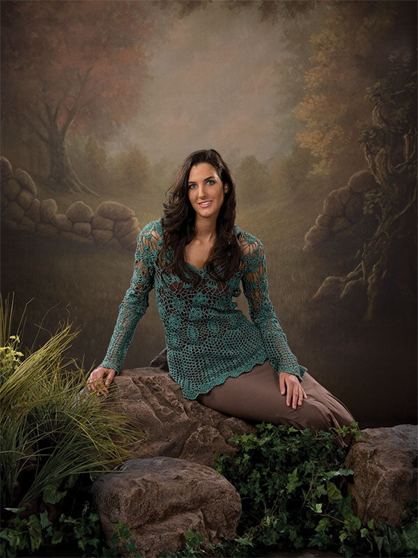 Background with open field, curved wall, and light-filled treetops.