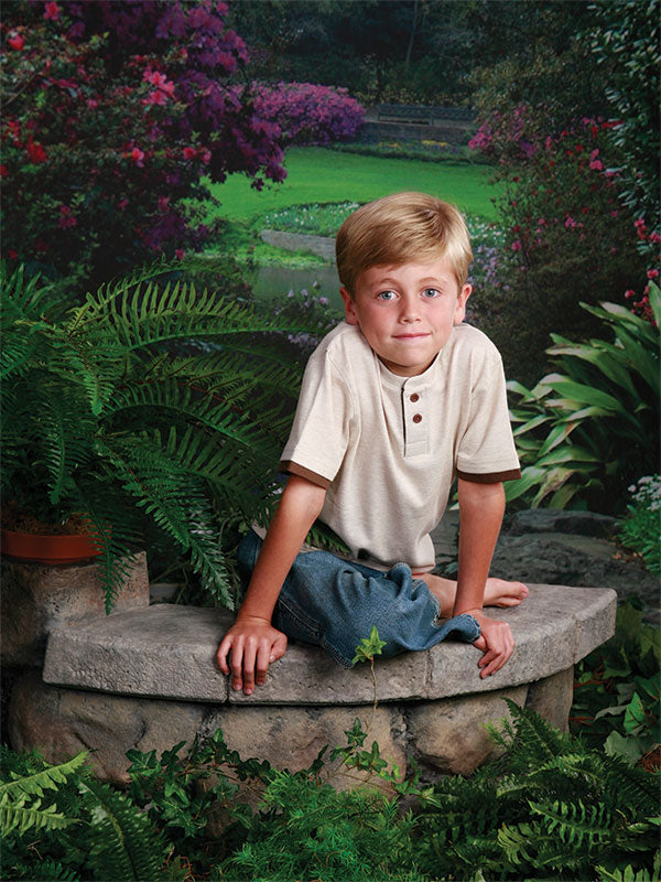 A professional photography backdrop capturing a peaceful Southern garden with a scenic path, blooming flowers, and natural greenery.