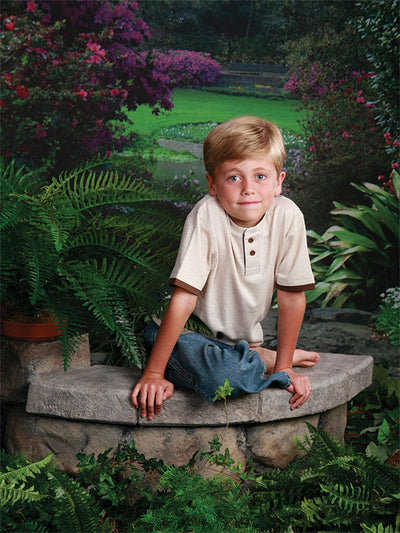 A professional photography backdrop capturing a peaceful Southern garden with a scenic path, blooming flowers, and natural greenery.