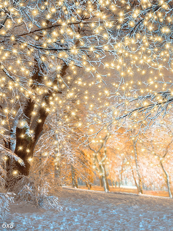 Sparkling Winter Wonderland Photography Backdrop - Snow-covered tree branches adorned with glowing golden lights in a winter forest photography backdrop.