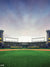 Stadium Sports Photography Backdrop - Stadium sports photography backdrop featuring a detailed green turf, grandstands, and a dynamic sky, perfect for sports-themed photoshoots.