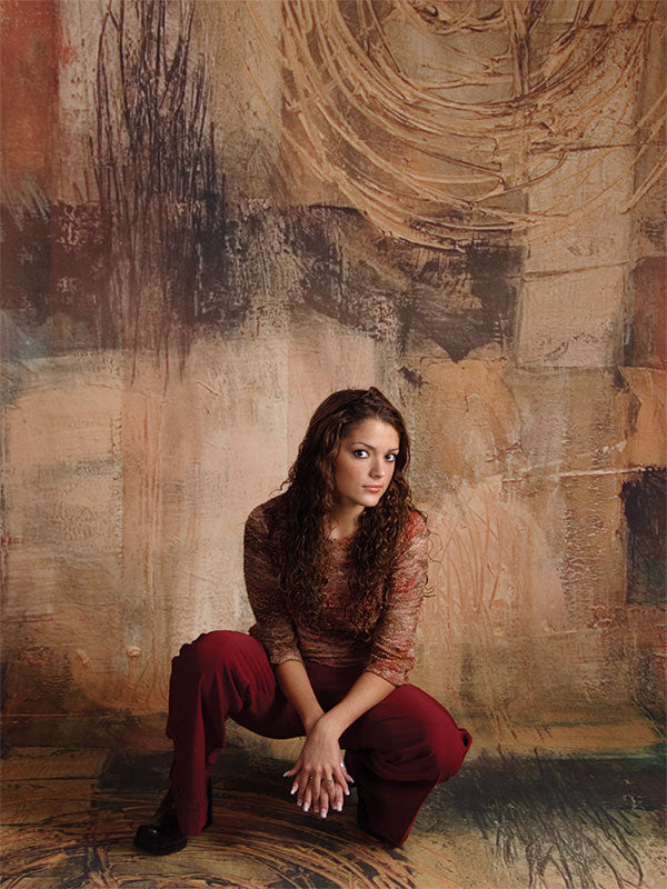 A painterly backdrop with copper spiral textures and warm undertones for expressive portraits.