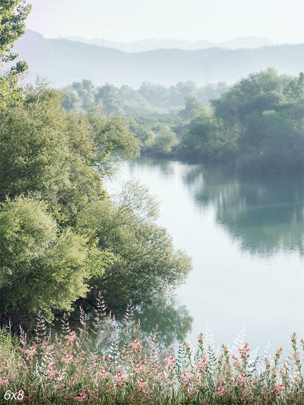 Tranquil Riverbank Photography Backdrop - Serene riverbank photography backdrop with misty trees, lush greenery, and soft wildflowers.