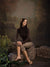 Peaceful forest edge with weathered tree, stone wall, and soft natural light.