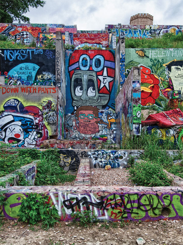 Urban Graffiti Terrace Photography Backdrop - Colorful urban terrace covered in diverse graffiti art with lush greenery surrounding the area.