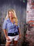 Gritty backdrop featuring peeling paint, exposed brick, and street-level realism.